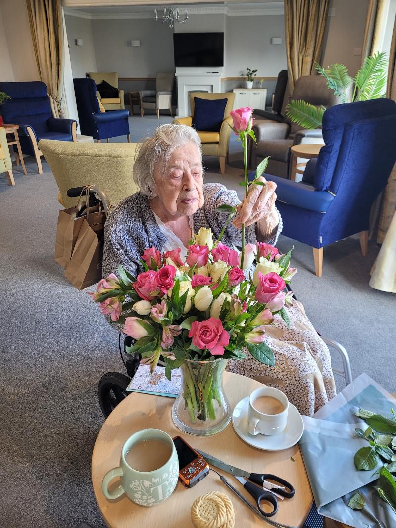 residents arranging flowers at lakeside watermead